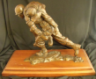 Bronze, one soldier carrying another on his shoulders, mounted on removable wooden base