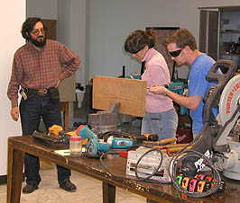 Julie and Trey use power drills