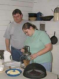 Todd and Maria demonstrate a butter churn