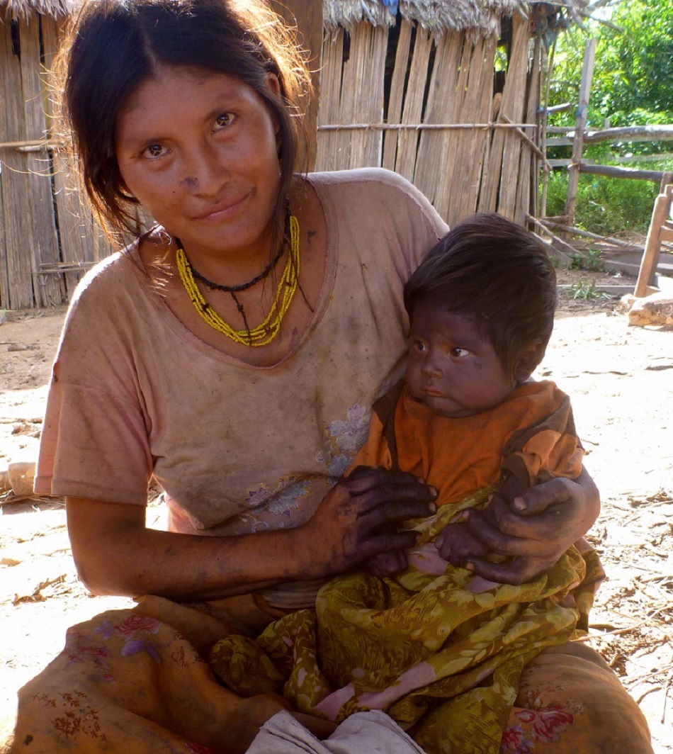 A mother holds her child in a developing nation