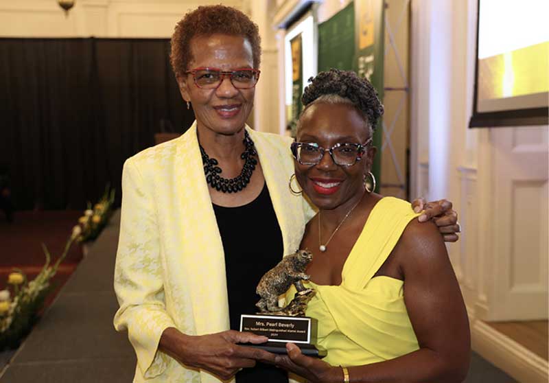 Marie Brown, B.A. ’92 (R) presents the Distinguished Black Alumni Award to Pearlie Beverly (L).
