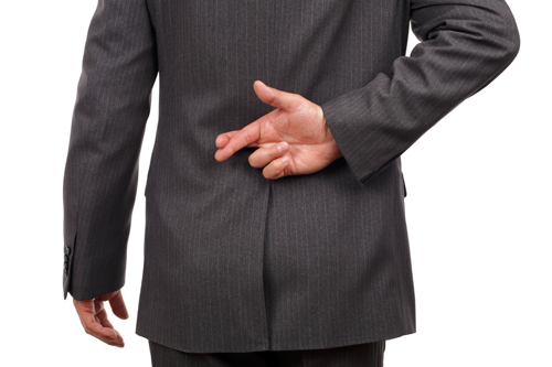 Stock photo of a businessman with his fingers crossed behind his back