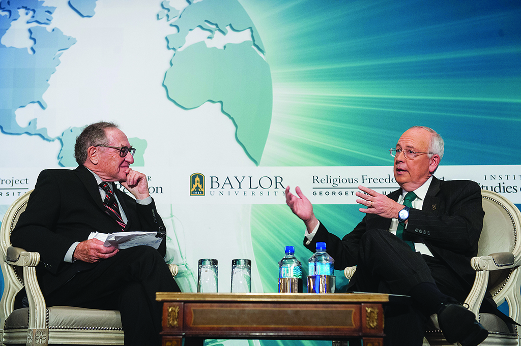 Photo of Ken Starr and David Green talking on stage