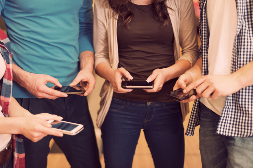 Cell Phones In Use By Everyone In The Photo