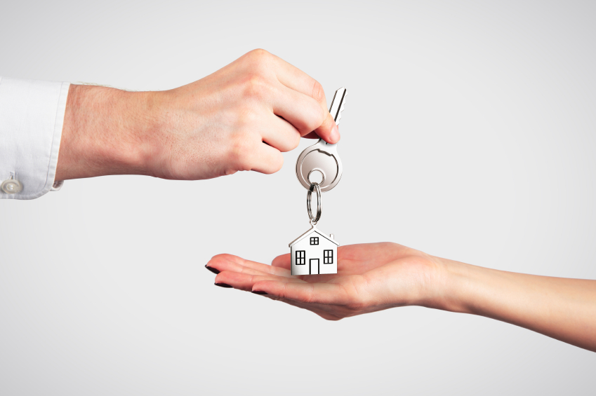 Stock photo of a person receiving a key to a new house