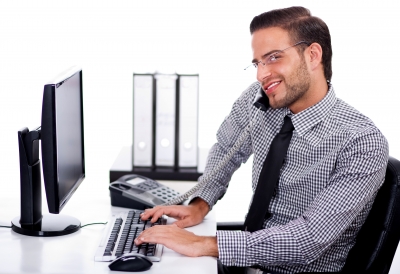stock photo of a business person on the phone and the computer at the same time