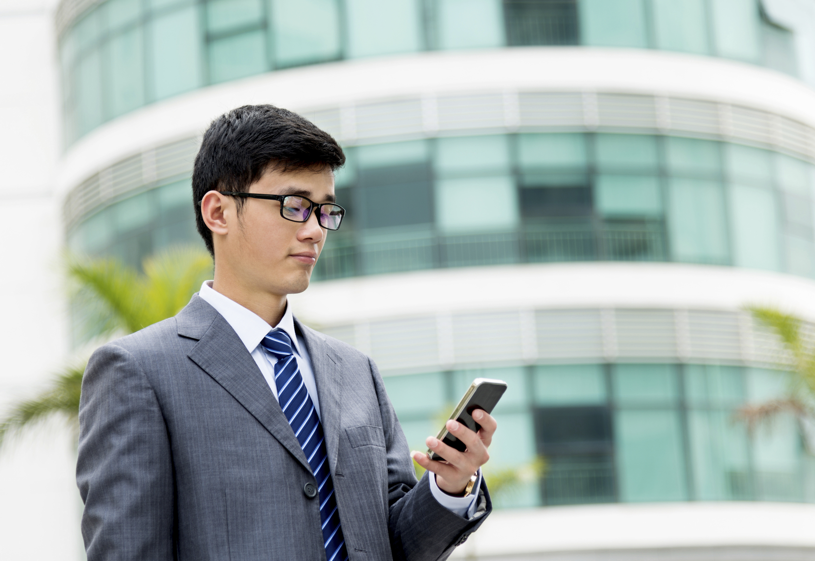 Stock photo of a businessman looking at his phone