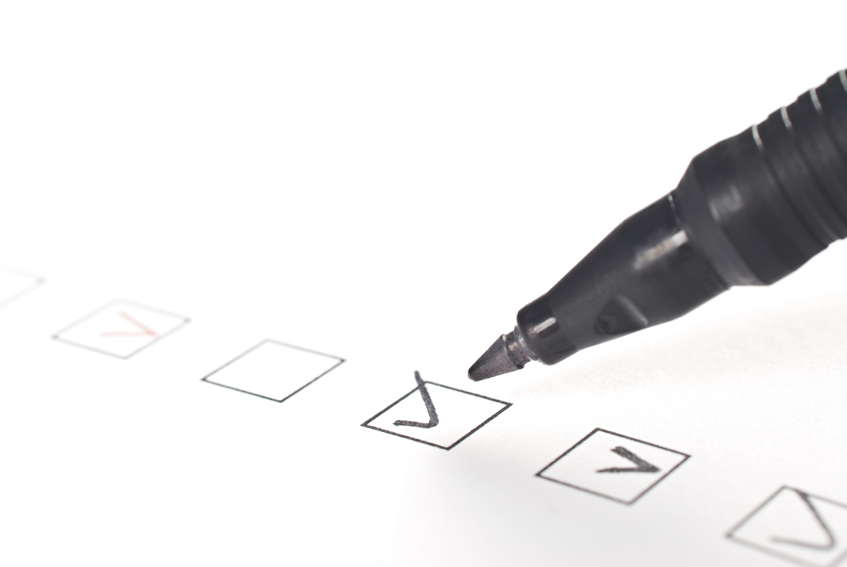 Stock photo of a pen making a check in a checkbox