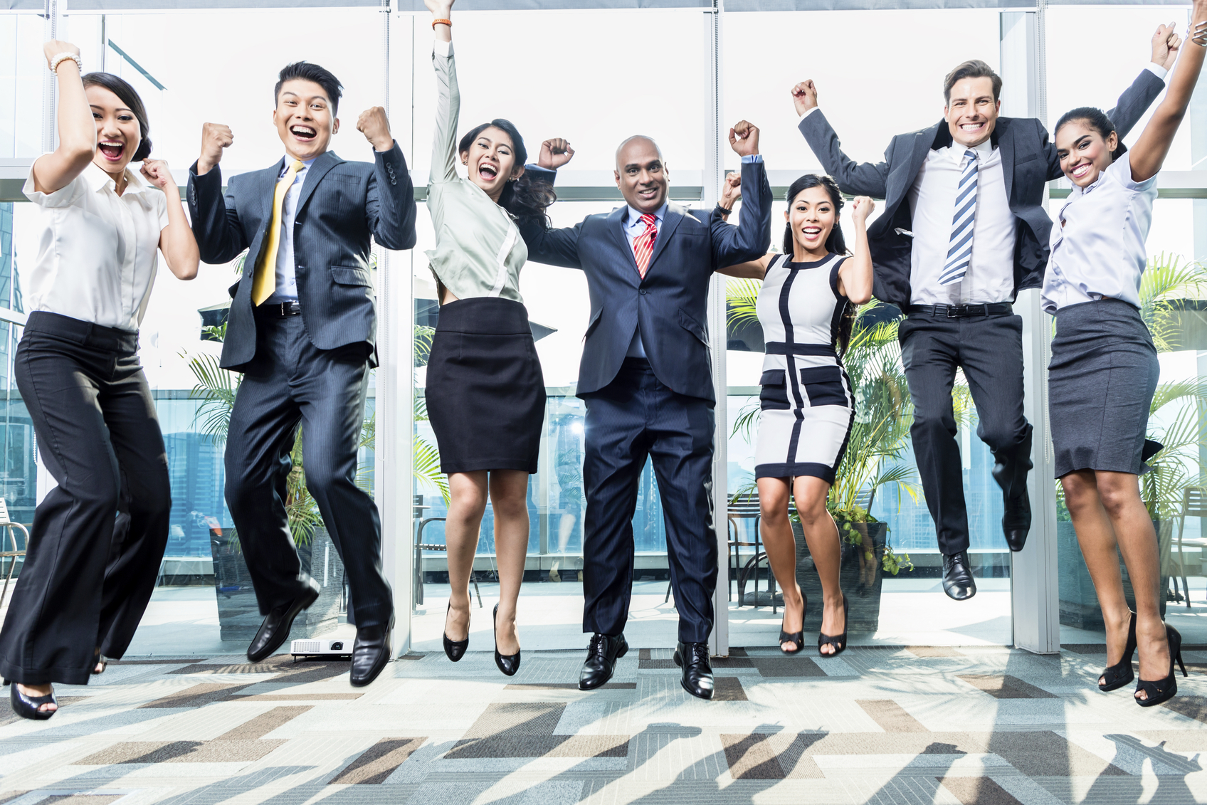 Stock photo of business men and women leaping