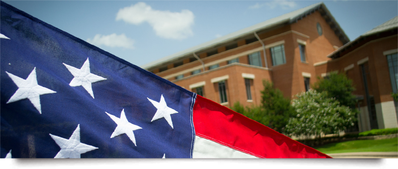 An American Flag flies over the Baylor Law School