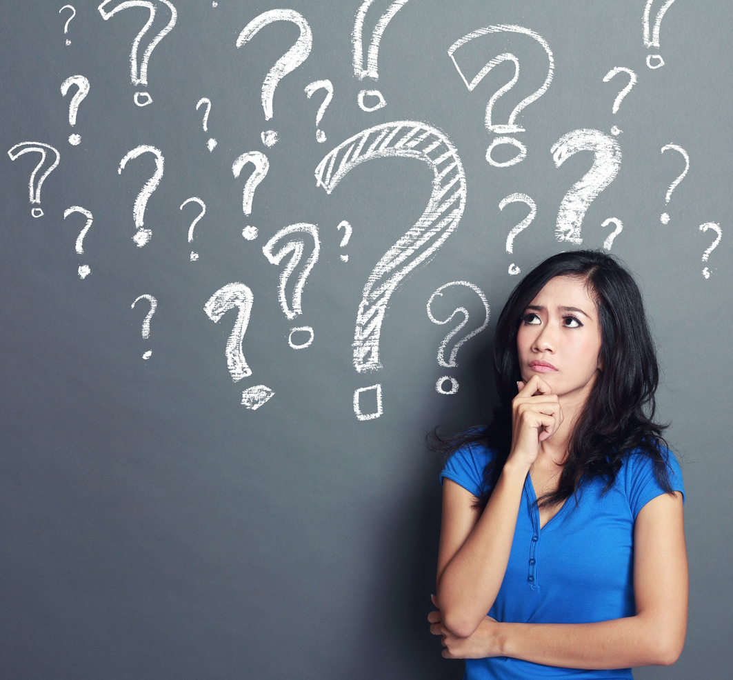 Stock photo of a woman, surrounded by question marks