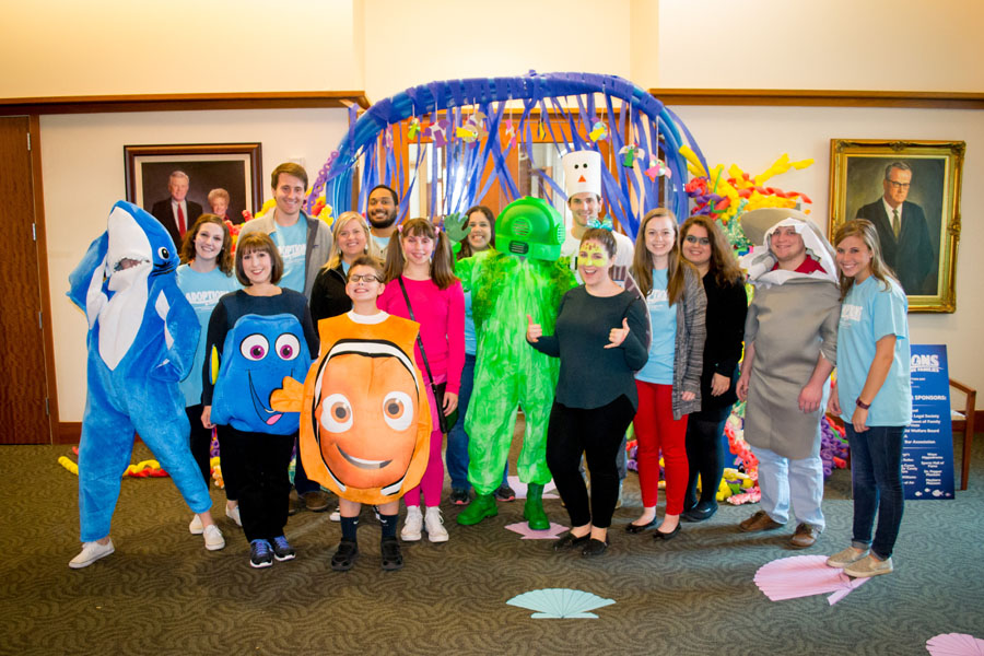 Students dress in Finding Nemo costumes and pose for a group photo on Adoption Day