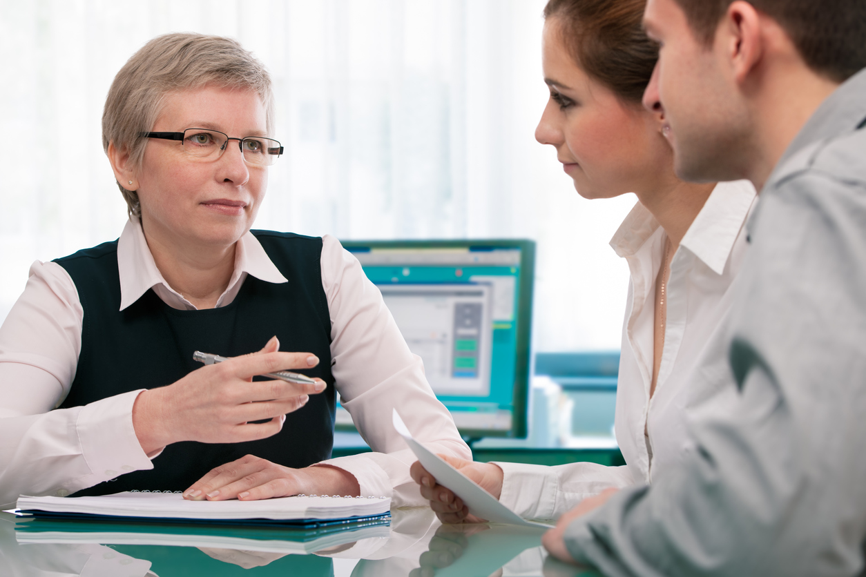 Stock photo of businesswoman counseling a young couple