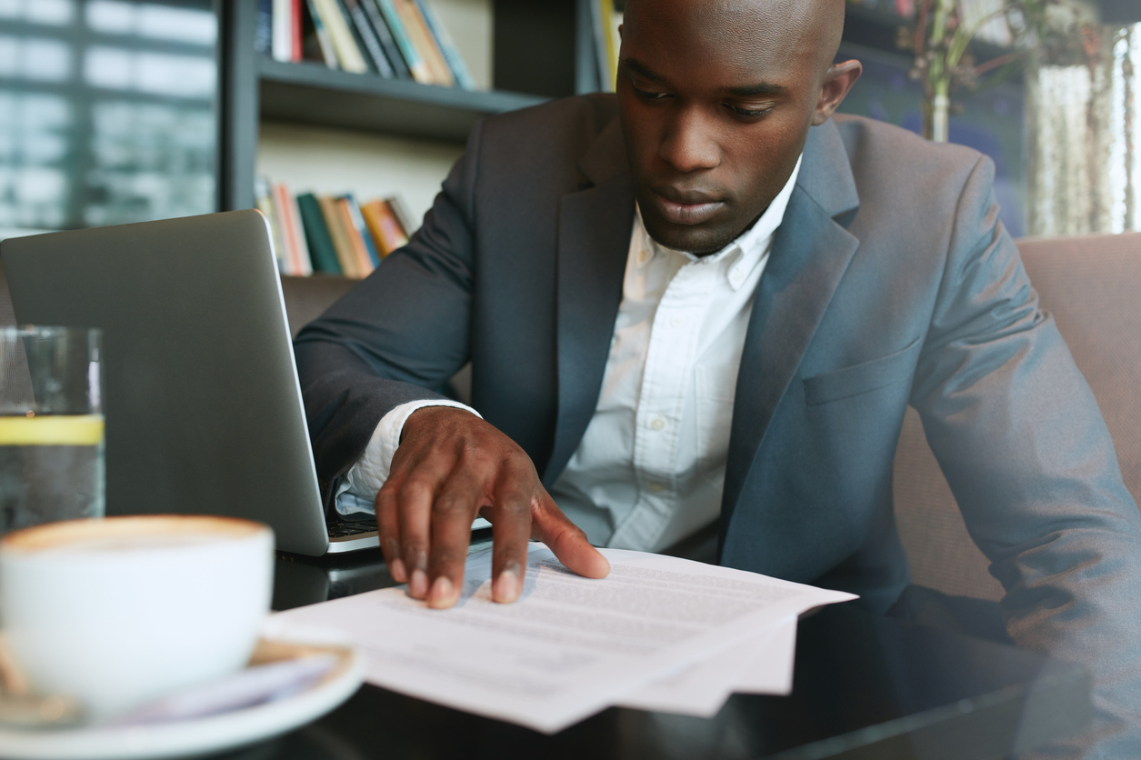 Stock photo of a businessman looking over paperwork