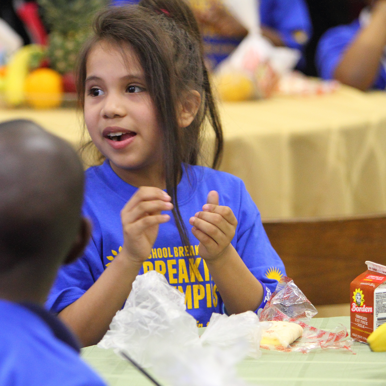 girl smiling in school cafeteria