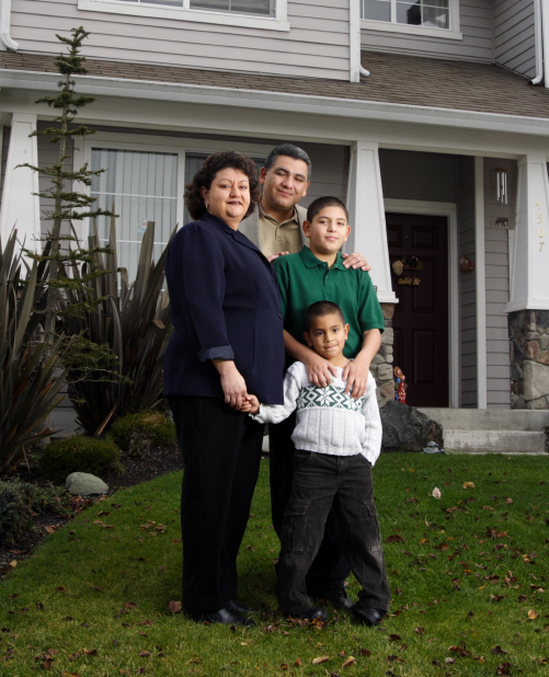 Stock photo of a family in front of a house