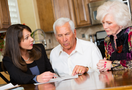 Stock photo of elder couple meeting with a realtor