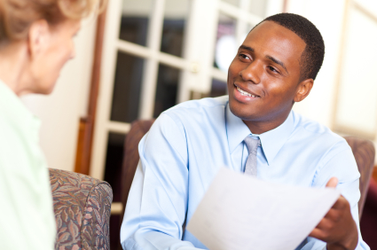 stock photo of a man holding paperwork to show to another person