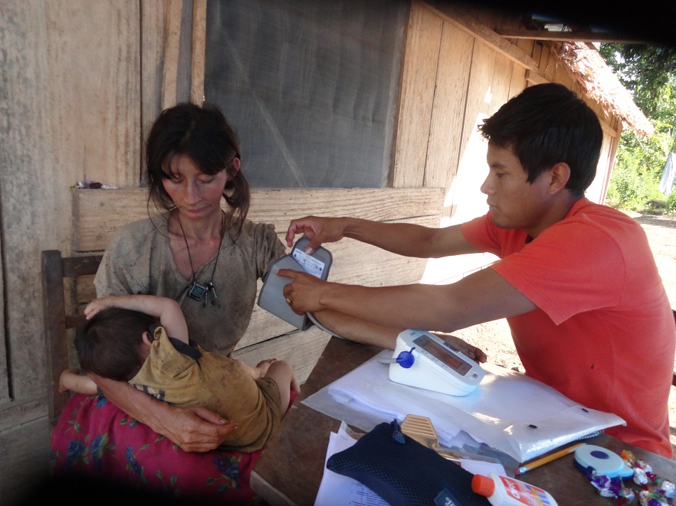 A student takes the blood pressure of a patient