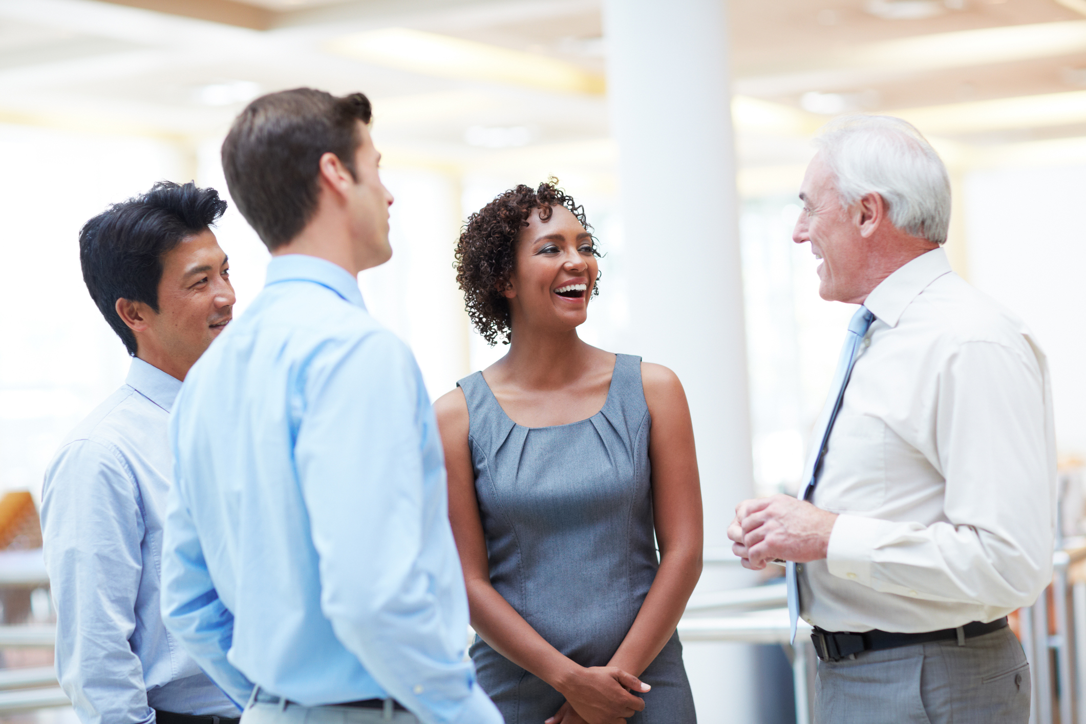 Stock Photo of businessmen and women meeting and laughing