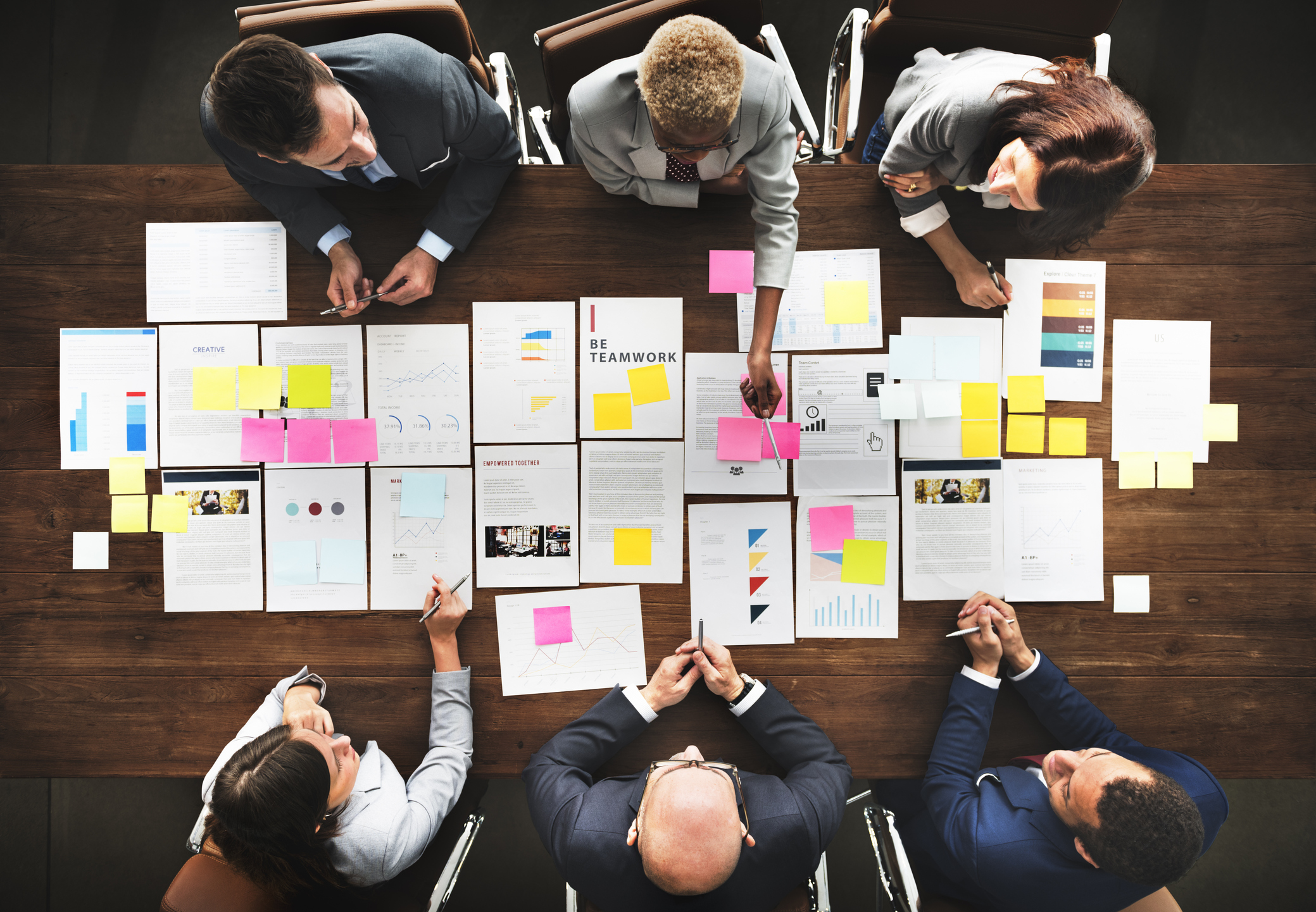 Stock photo of a business team at a table working on a group project