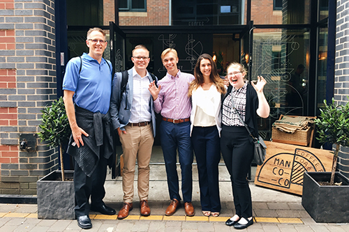 A cohort gathers in front of a coffee shop in the UK