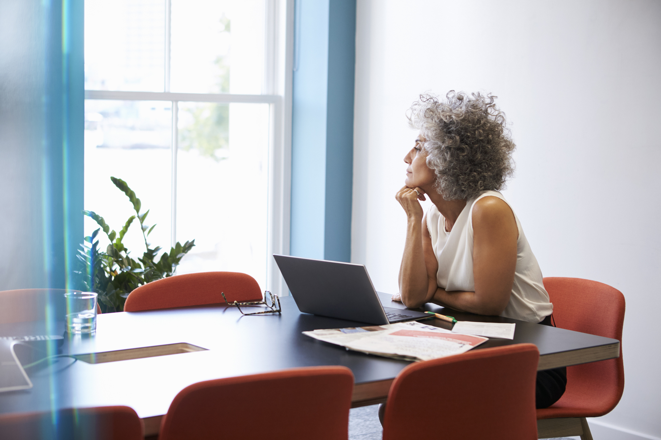 Stock photo of a business woman looking out the window