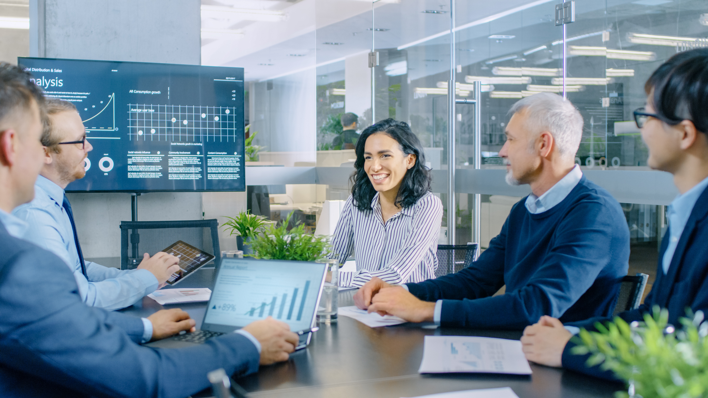 Stock Photo of business meeting with charts and graphs on display