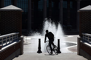 bicyclist in front of fountain