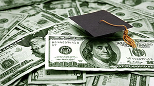 Stock Photo of a Graduation Cap atop a pile of cash