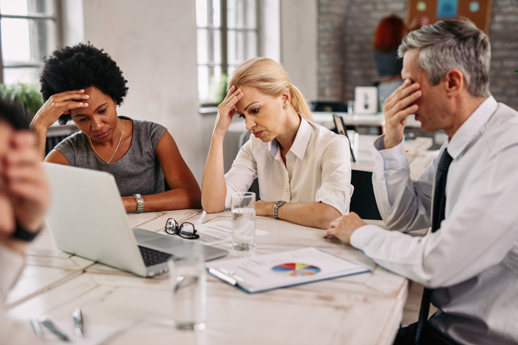 Stock photo of frustrated businessmen and women at a meeting