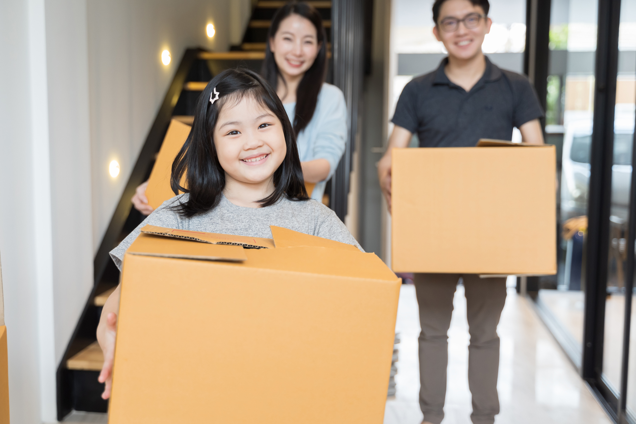 Stock photo of a family moving boxes