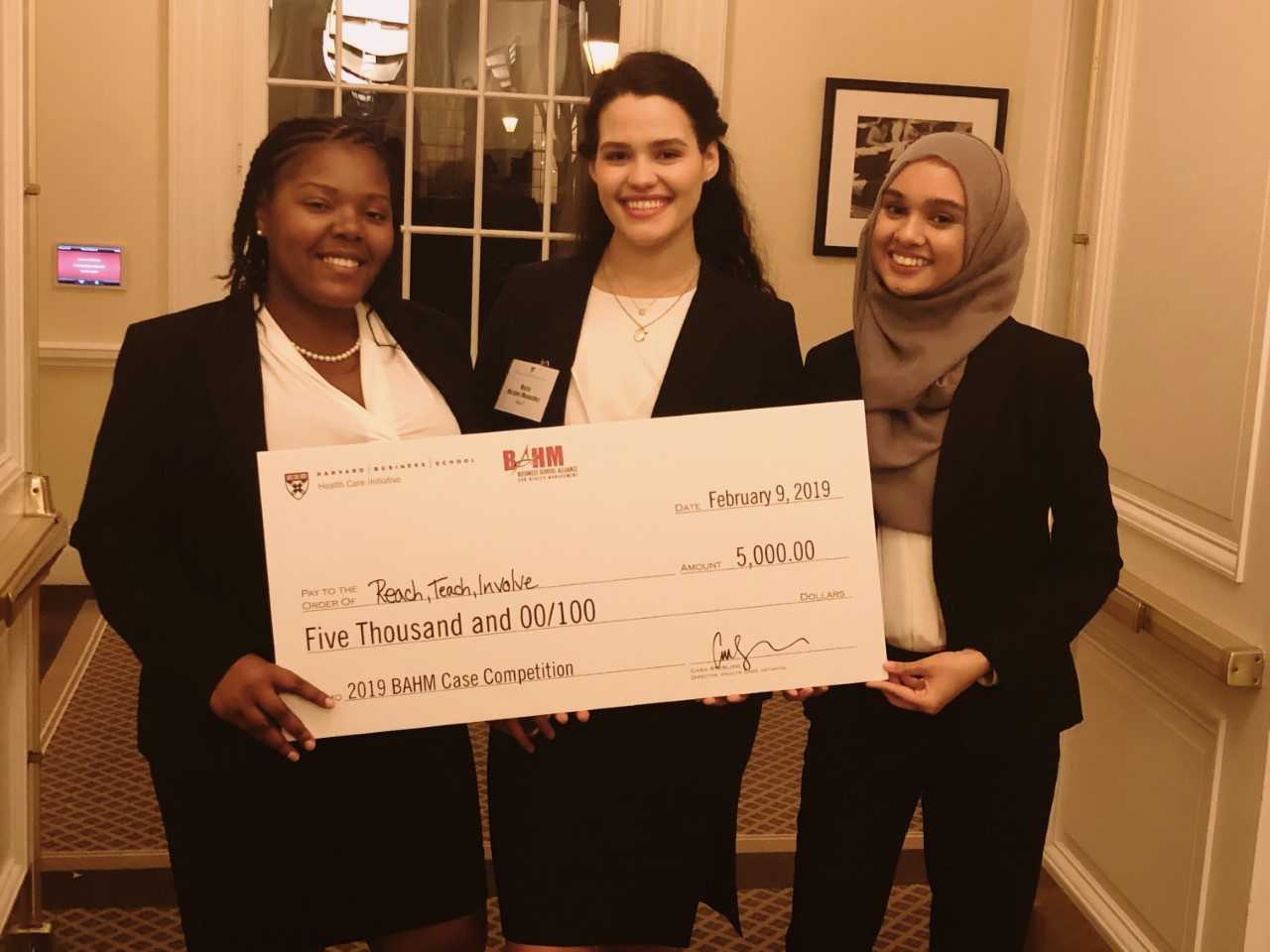 Group photo of the winners accepting their check