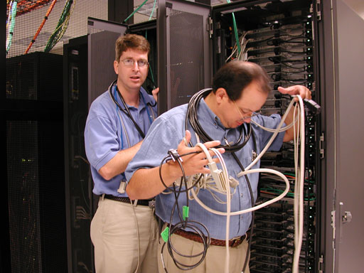 Photo of technicians acting like they're stuck in network cabling