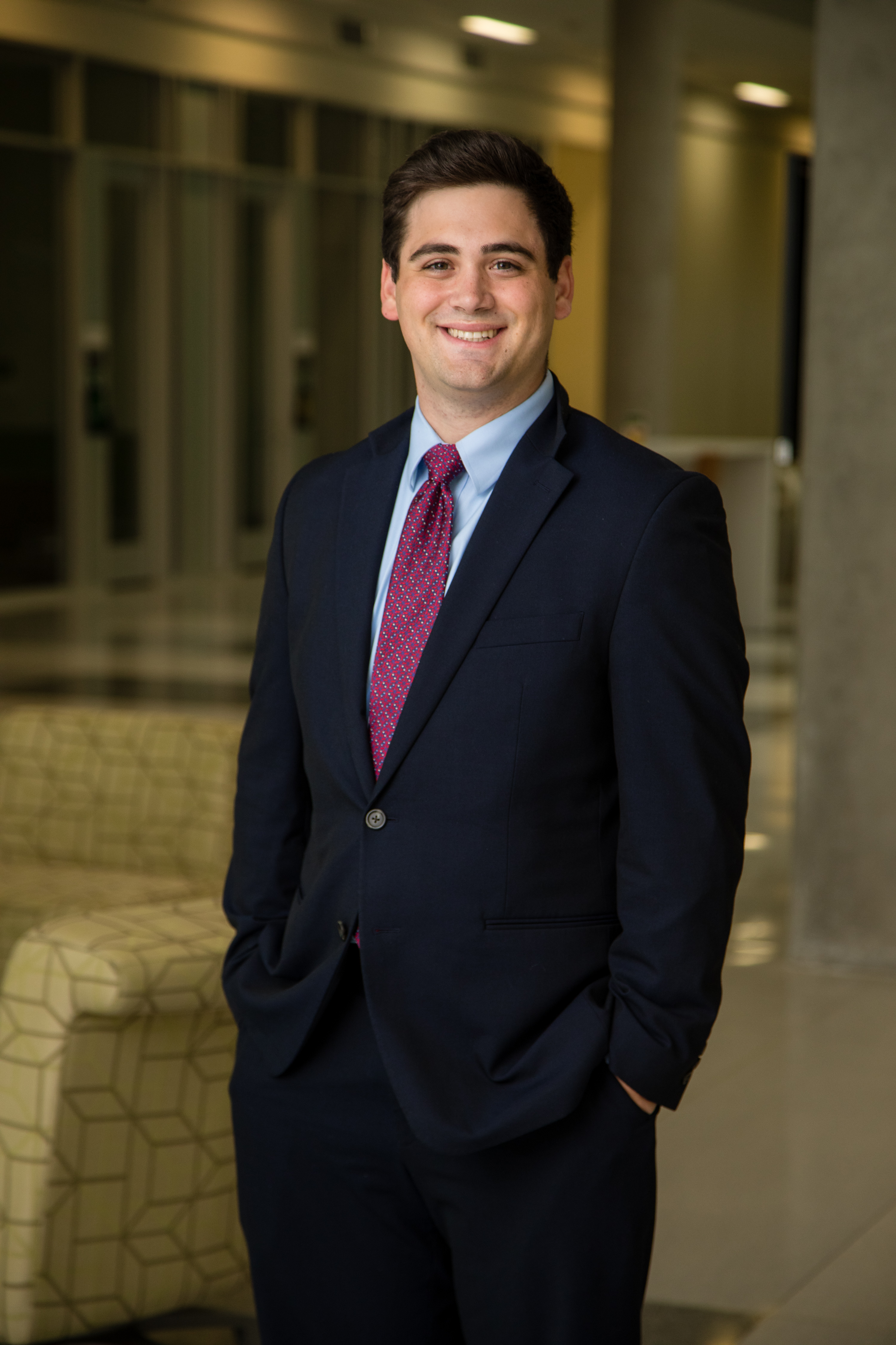 Blake Matthews in a suit posing indoors