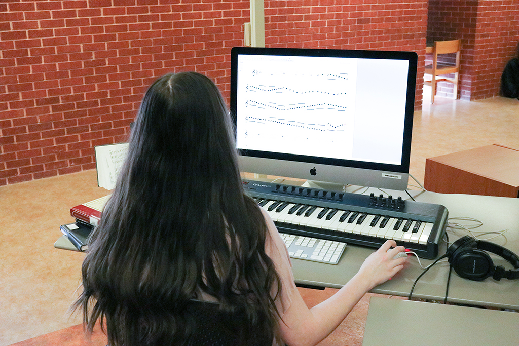 Photo of a student practicing at a keyboard