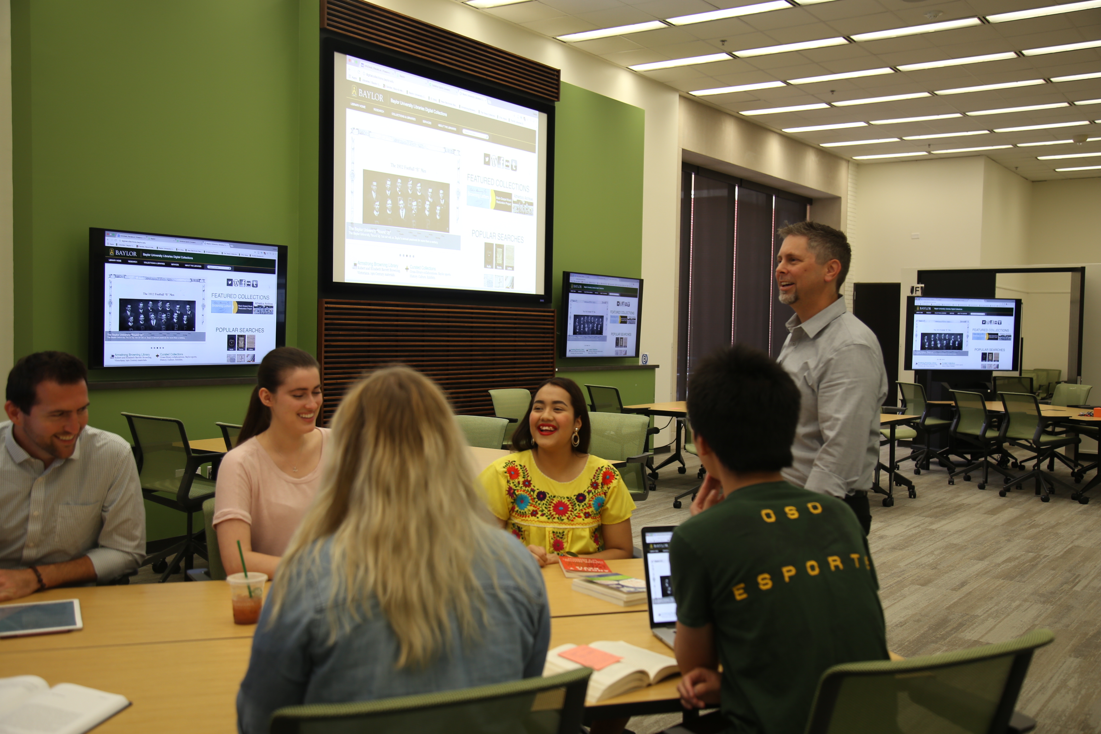 Photo of Sha Towers teaching with technology in the library.