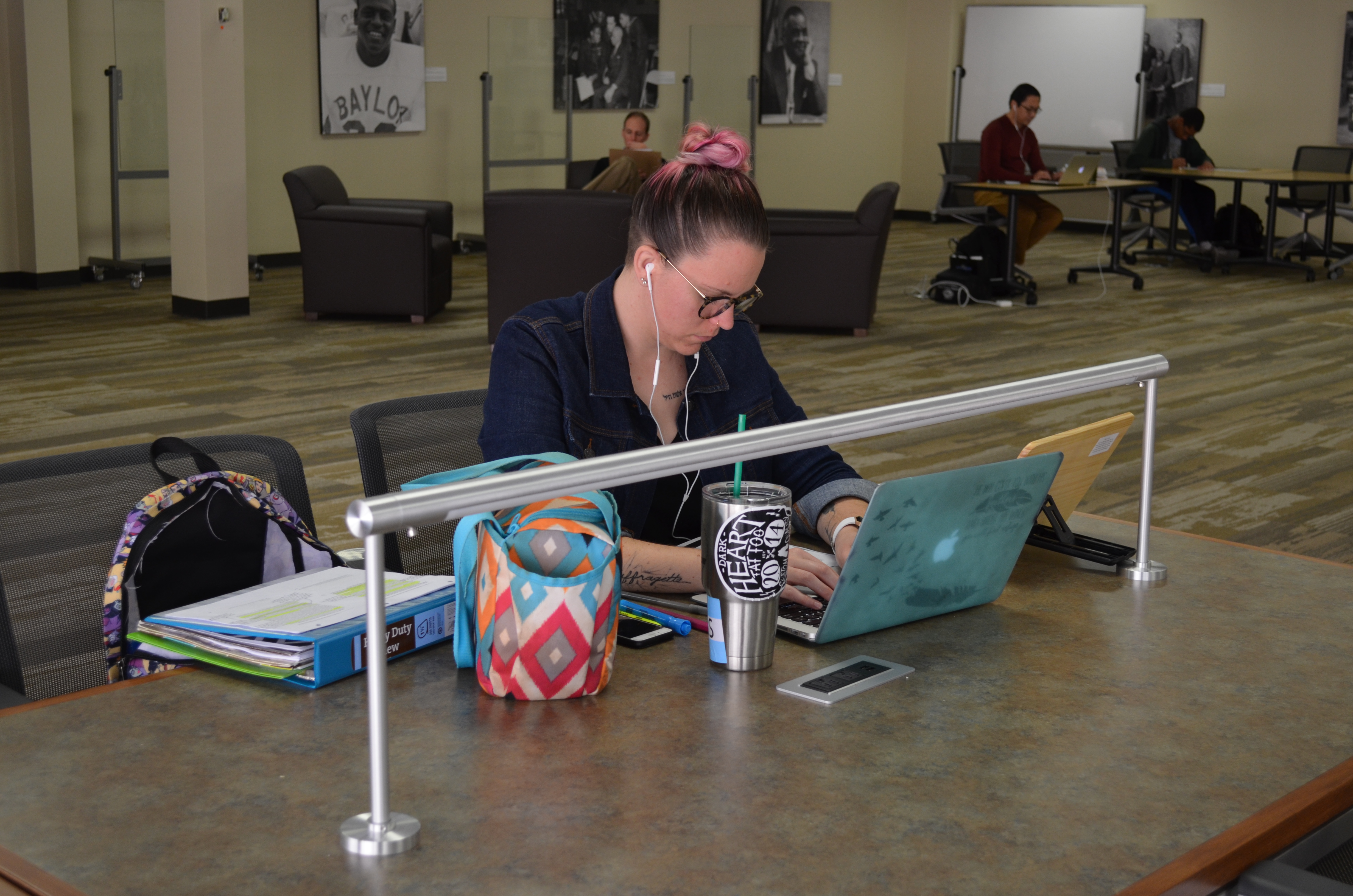 Banner image of graduate student studying at a table in the Graduate Research Center