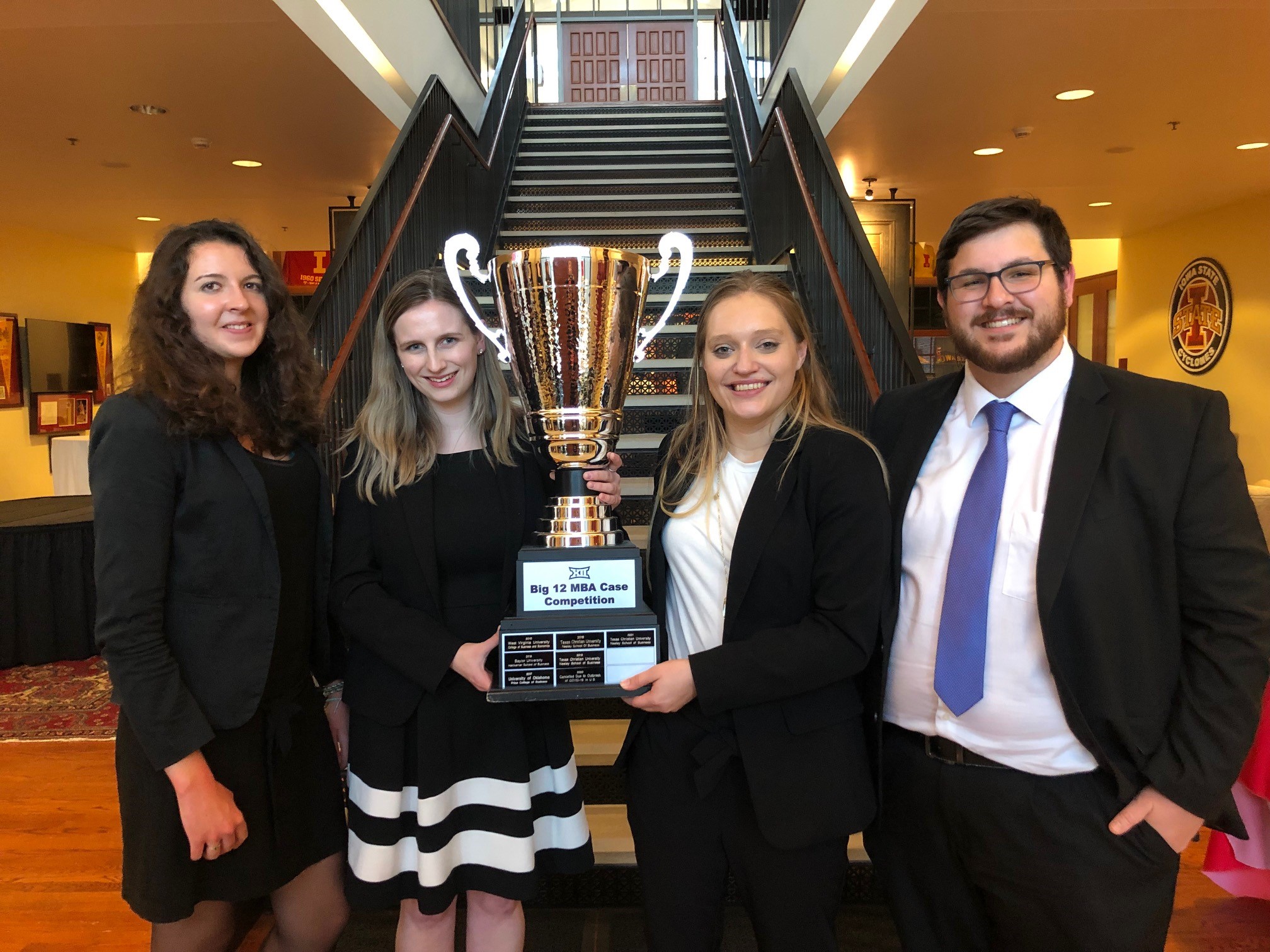 Four Baylor MBA Students holding a trophy