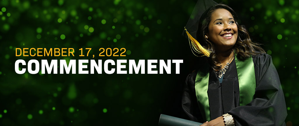 A student crosses the stage during graduation at the Ferrell Center.